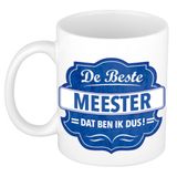Bellatio Decorations De beste meester cadeau koffiemok / theebeker wit met blauw embleem - 300 ml - keramiek - cadeaumok meester