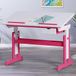 Inter Link – In hoogte verstelbaar bureau – kinderbureau – studentenbureau – kantelverstelling – boekenhouder – massief hout wit gelakt – applicaties in roze – roze/wit