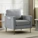 Fauteuil gris en tissu haut confort, pieds métalliques dorés, rangements latéraux, pour salon, bureau ou chambre