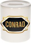 Bellatio Decorations Spaarpot met voornaam Conrad - wit - met goud/zwart embleem - 8 x 9 cm - keramiek - met afsluitdop - cadeau verjaardag