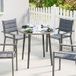 Table de jardin avec plateau en verre trempé et bordure en rotin, structure en acier, 80 x 80 x 74 cm, grise