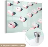 MuchoWow® Glasschilderij 150x100 cm - Snoepjes op een munt groene achtergrond - Foto op glas - Acrylaat - Multicolor