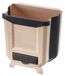 Poubelle pliable pour cuisine, suspendue à un meuble, avec espace pour sacs poubelles.