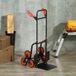 Chariot de transport pliable 120 kg max, poignée télescopique, 44 x 38 x 106,5 cm, rouge et noir