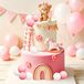 Rosa décoration de gâteau pour fête de bébé avec un cheval à bascule