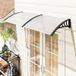 Auvent extérieur transparent de 195 x 75 cm en polycarbonate et aluminium pour fenêtres et portes de balcon.